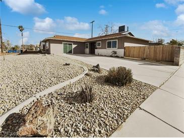 Single story home featuring desert landscaping, long driveway, and neutral exterior paint at 6421 Dinning Ave, Las Vegas, NV 89107