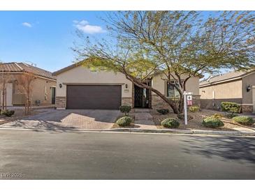 Inviting single-story home featuring a well-manicured yard and a two-car garage at 7153 Tavita St, Las Vegas, NV 89113