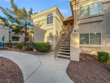 Condominium exterior with maintained landscaping, stairs leading to the units, and pathway at 7400 W Flamingo Rd # 2022, Las Vegas, NV 89147