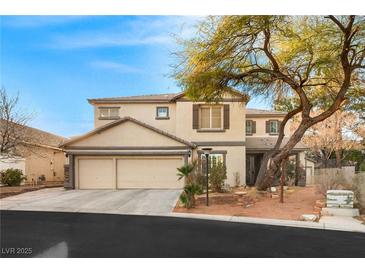 Inviting two-story home with a three car garage and well-maintained front yard at 7840 Red Leaf Dr, Las Vegas, NV 89131