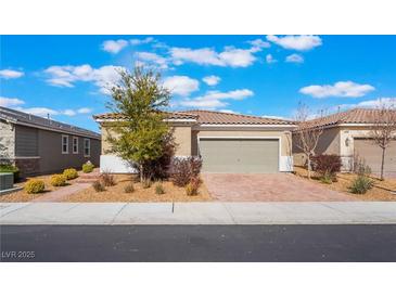 Charming single-story home featuring desert landscaping, a brick driveway, and a two-car garage at 2910 Ventana Ridge Ave, Henderson, NV 89044