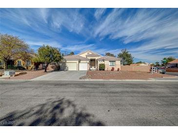 Charming single-story home with a well-maintained lawn and a spacious three-car garage at 344 E Rush Ave, Las Vegas, NV 89183