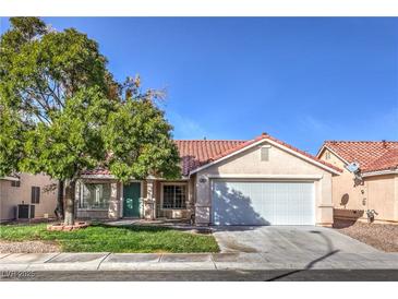 Charming single-story home featuring a 2-car garage, tile roof, mature tree, and well-maintained lawn at 7021 Feather Pine St, Las Vegas, NV 89131