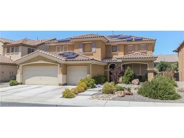 Beautiful two-story home with a three-car garage, tiled roof, solar panels, and lovely xeriscaped front yard at 764 Canary Wharf Dr, Las Vegas, NV 89178