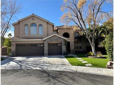 Charming two-story home featuring a three-car garage and stone accents at 1705 Pink Cliff Ct, Las Vegas, NV 89128