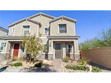 Charming townhome features a well manicured front yard with decorative stone and fresh landscaping at 1803 Potosi Peak Ave, North Las Vegas, NV 89031