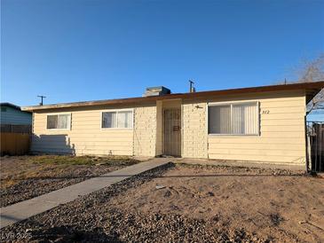 Charming single-story home with a low-maintenance front yard and a classic desert landscape at 1912 W Carey Ave, North Las Vegas, NV 89032