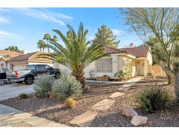 Charming single-story home with desert landscaping, stone walkway, and a well-maintained front yard at 2129 Sun Swept Way, Henderson, NV 89074