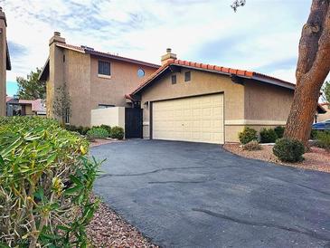 Charming home showcasing a two-car garage and well-manicured landscaping at 3999 Delos Dr, Las Vegas, NV 89103