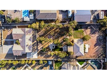 Expansive property features desert landscaping, putting green, pool, mature trees, and circular driveway at 4245 N Campbell Rd, Las Vegas, NV 89129