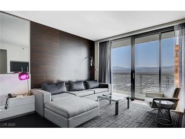 Bright living room with a sectional sofa, city view and modern decor at 4381 W Flamingo Rd # 3007, Las Vegas, NV 89103
