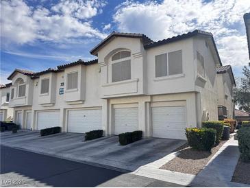 Three-story townhome boasts a neutral palette and attached one-car garage at 7231 Indian Creek Ln # 204, Las Vegas, NV 89149