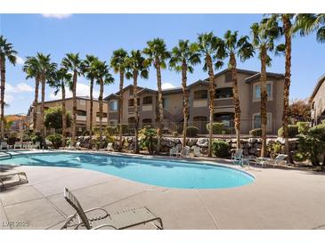 Enjoy the community pool surrounded by palm trees and meticulously kept landscaping at 8805 Jeffreys St # 2002, Las Vegas, NV 89123