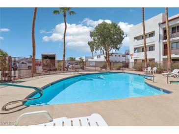 Enjoy this community pool on a beautiful day with palm trees and ample seating at 1381 E University Ave # 301, Las Vegas, NV 89119