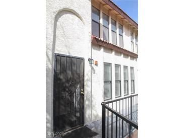 View of the front entry with a security door, and stucco walls at 2080 Karen Ave # 21, Las Vegas, NV 89169