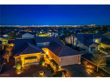 Stunning exterior view of a single-story home featuring a red-tile roof and a spacious two-car garage at 2720 Spalding Dr, Las Vegas, NV 89134