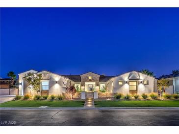 Stunning single-story home boasts a well manicured lawn, exterior lighting, and stylish landscaping at 3731 Caesars Cir, Las Vegas, NV 89120