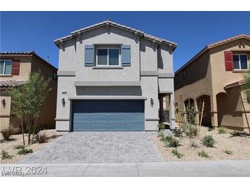 Charming two-story home featuring a blue garage door and beautiful neutral colored exterior at 5269 Acadia Leaf St, Las Vegas, NV 89166