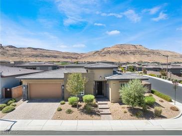 Charming single-story home featuring desert landscaping and a brick driveway at 6801 Steel Mist St, Las Vegas, NV 89148