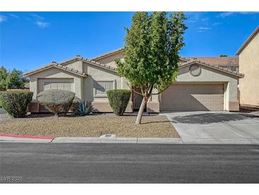 Charming single-story home featuring a well-maintained front yard with desert landscaping and a two-car garage at 2705 Brill St, Las Vegas, NV 89108