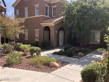 Inviting two-story home featuring meticulously maintained landscaping, walkway, and charming curb appeal at 3850 Juno Beach St # 203, Las Vegas, NV 89129