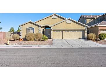 Inviting single-story home showcasing a three car garage and desert landscaping at 6360 Bullring Ln, Las Vegas, NV 89130