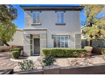 Charming two-story home with well-maintained landscaping and neutral colors at 1420 Ibizo St, Las Vegas, NV 89117