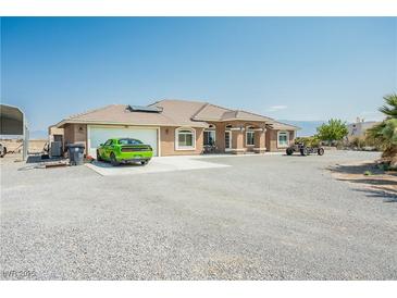 Charming single-story home with a two-car garage and ample parking on a gravel driveway at 1920 Silver St, Pahrump, NV 89048