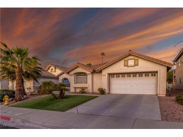 Charming single-story home with a well-manicured lawn and a two-car garage in a residential neighborhood at 254 Camelback Ridge Ave, Henderson, NV 89012