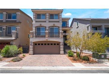 Charming three-story home features a balcony, tile roof, and brick driveway at 7029 Parrot Bay Way, Las Vegas, NV 89118