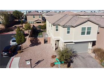 Inviting two-story home with manicured front yard and charming curb appeal on a sunny day at 9216 Verdugo Ridge Ct, Las Vegas, NV 89148