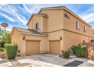 Tan two-story home with two-car garage, easy to maintain landscaping, and a tile roof at 9517 Alma Ridge Ave, Las Vegas, NV 89178