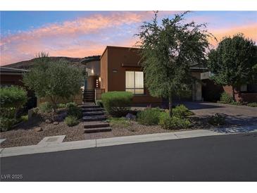 Charming single-story home with desert landscaping, brick walkway, and a two-car garage at 10057 Regency Canyon Way, Las Vegas, NV 89148