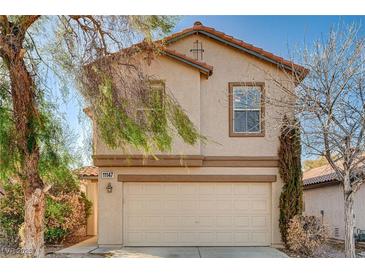Two-story stucco home with a two-car garage and low maintenance desert landscaping at 11147 Verismo St, Las Vegas, NV 89141