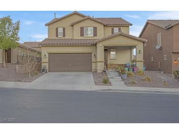 Charming two-story home with a well-maintained yard, front porch, and two car garage at 193 Calabria Peak Ct, Henderson, NV 89012