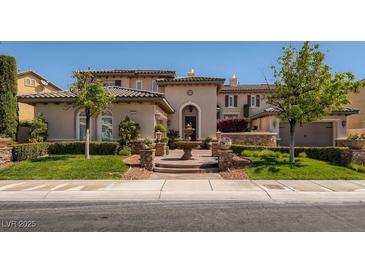 Elegant home featuring a well-manicured lawn, stone accents, and a charming fountain at 2038 Cherry Creek Cir, Las Vegas, NV 89135