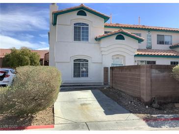 Charming two-story home with stucco exterior, arched windows and a concrete driveway at 2736 Stargate St, Las Vegas, NV 89108