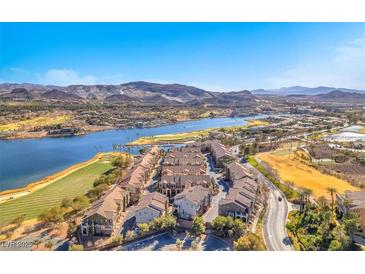 Scenic aerial view of waterfront homes, golf course, lake and mountains in the background on a clear day at 1 Corte Belleza, Henderson, NV 89011
