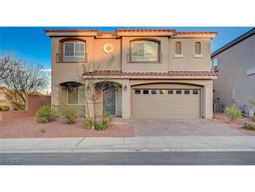 Charming two-story home features desert landscaping, a tile roof, and an attached two-car garage at 10306 Coastline Creek Ct, Las Vegas, NV 89141