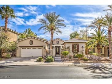 Charming single-story home with well-manicured landscaping and desert accents, including palm trees at 1477 Foothills Village Dr, Henderson, NV 89012