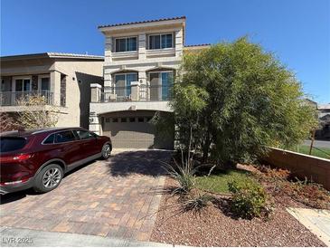 Charming two-story home featuring a paved driveway, a well-maintained lawn, and a two-car garage at 7068 Parrot Bay Way, Las Vegas, NV 89118