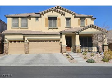 Inviting two-story home with a three-car garage and well-maintained landscaping at 10220 Radcliffe Peak Ave, Las Vegas, NV 89166