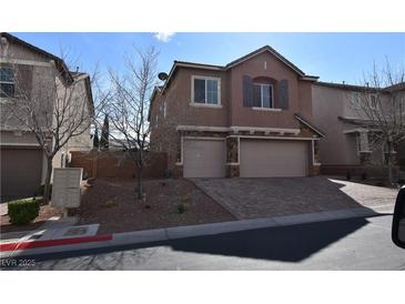 Charming two-story home with a two-car garage and a well-maintained front yard at 10511 Loma Portal Ave, Las Vegas, NV 89166