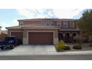 Charming two-story home featuring a terracotta roof and a spacious three-car garage at 1633 Dornie Ave, North Las Vegas, NV 89084