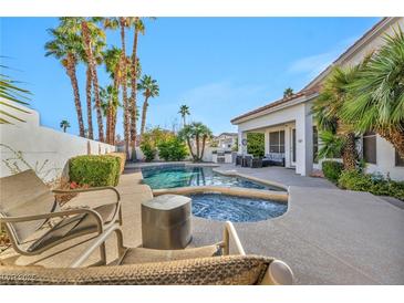 Beautiful backyard pool with a spa and lush landscaping is perfect for outdoor entertaining at 174 Buena Ct, Henderson, NV 89074