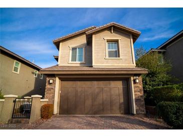 Charming two-story home with stone accents and a two-car garage, complemented by a well-manicured brick driveway at 343 Cadence Vista Dr, Henderson, NV 89011