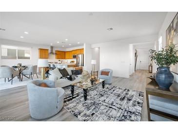 Bright, open-concept living room with modern decor, seamlessly connecting to the kitchen and dining areas at 1722 Game Garden Rd, North Las Vegas, NV 89031