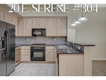Modern kitchen with granite counters, stainless steel appliances, and ample cabinet space at 20 E Serene Ave # 304, Las Vegas, NV 89123