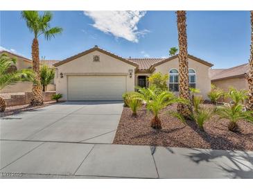 Charming single-story home featuring desert landscaping, a two-car garage, and a neutral color palette at 2119 Lewiston Pl, Henderson, NV 89044