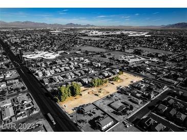 Wide aerial shot of the land for sale, surrounded by neighborhood homes in a mature community at 2294 N Pecos Rd, Las Vegas, NV 89115